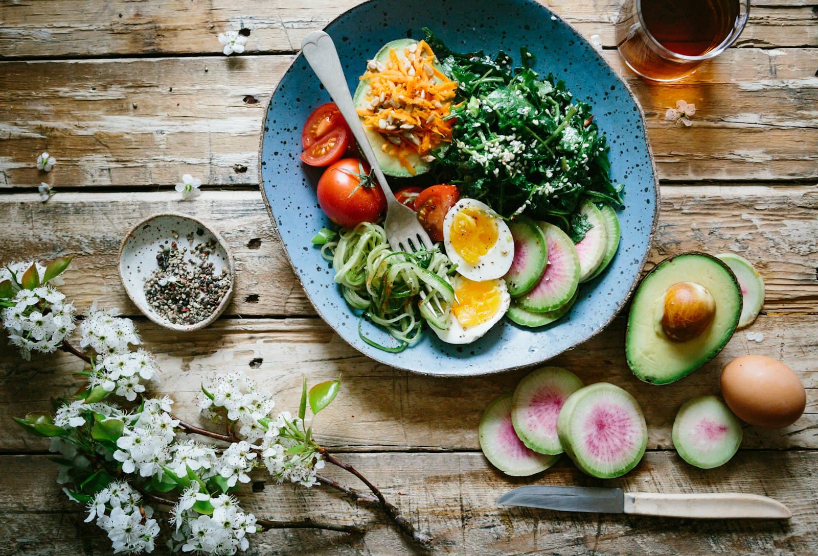 Salad bowl on a wooden table, top-down